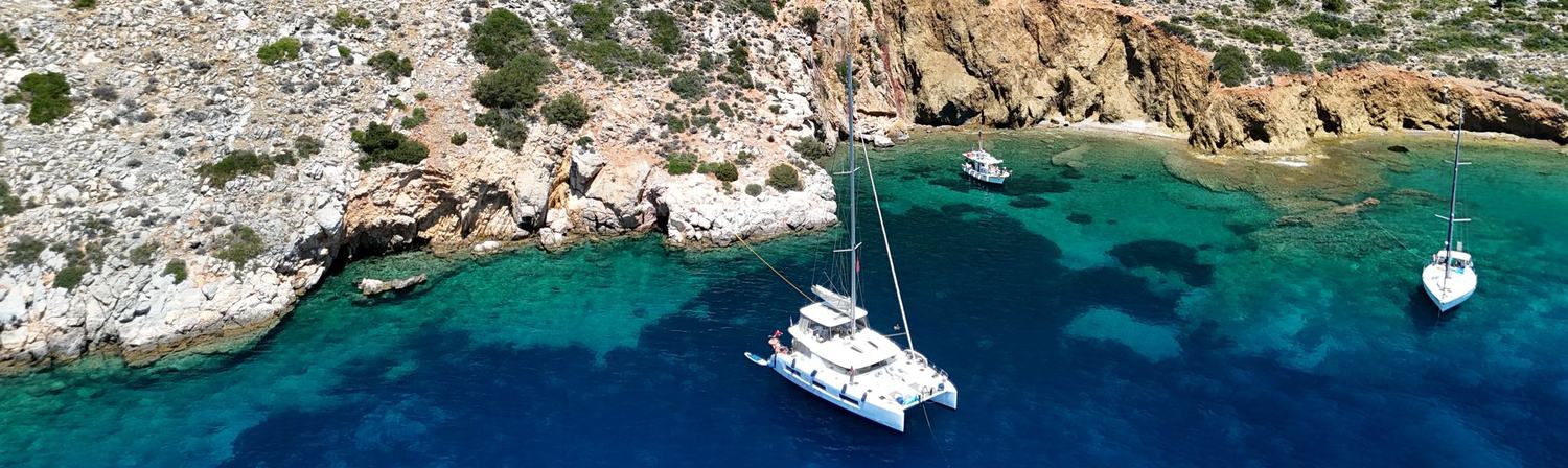 An Ethos catamaran at anchor in a quiet bay