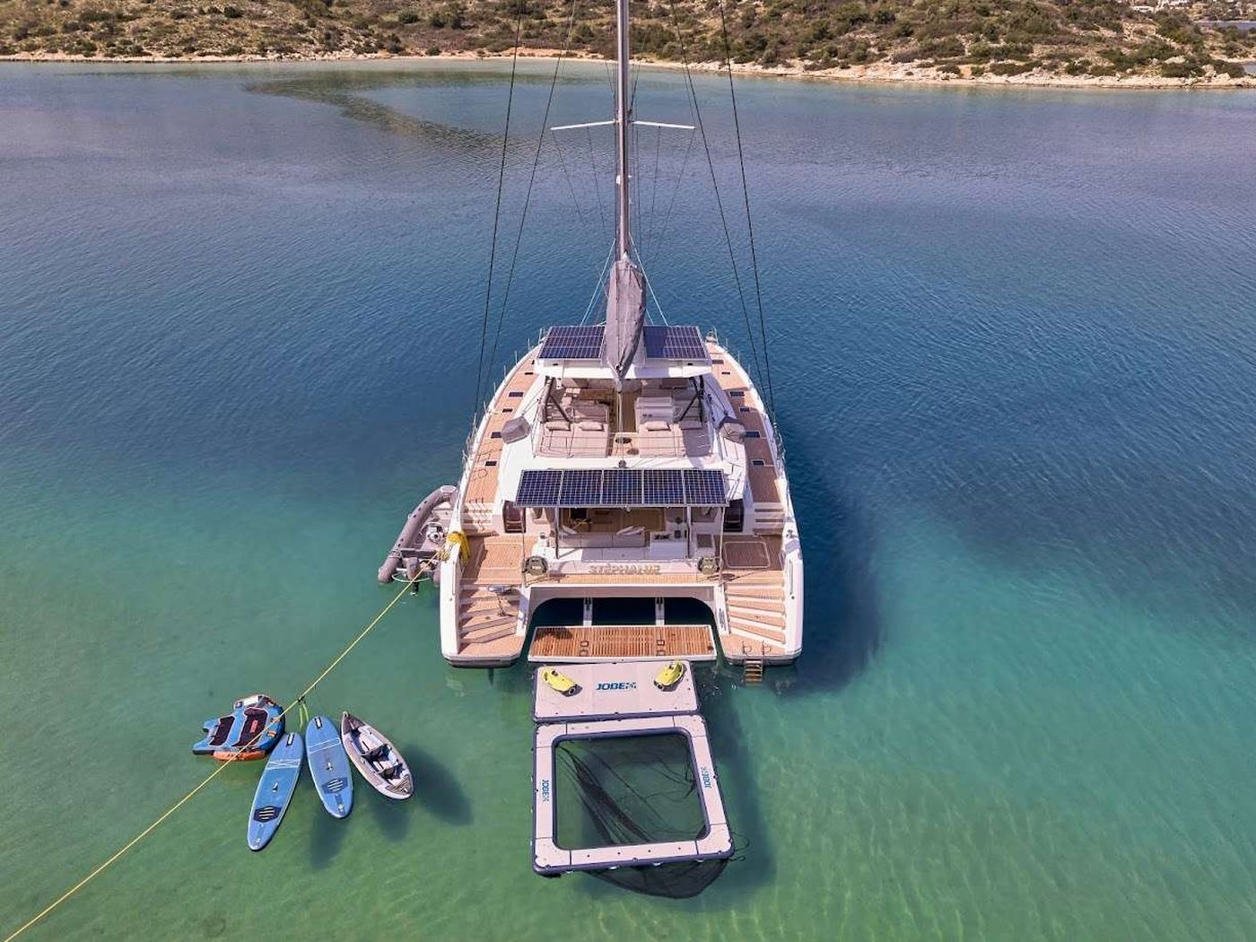 A crewed catamaran under sail